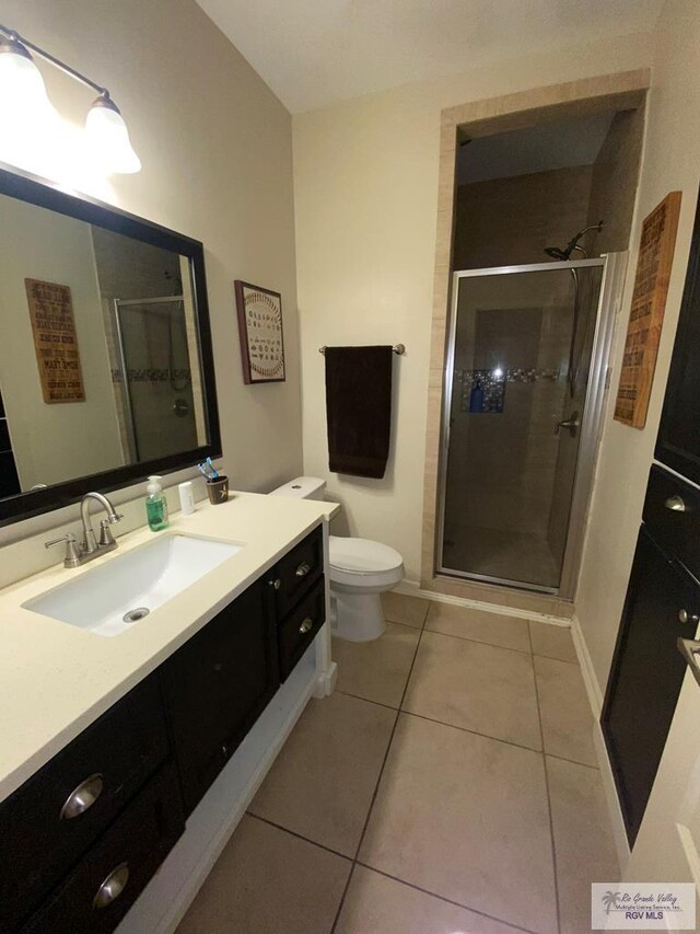 116 Village E Dr, Los Fresnos, TX 78566 - bathroom with vanity, a stall shower, toilet, and tile patterned flooring