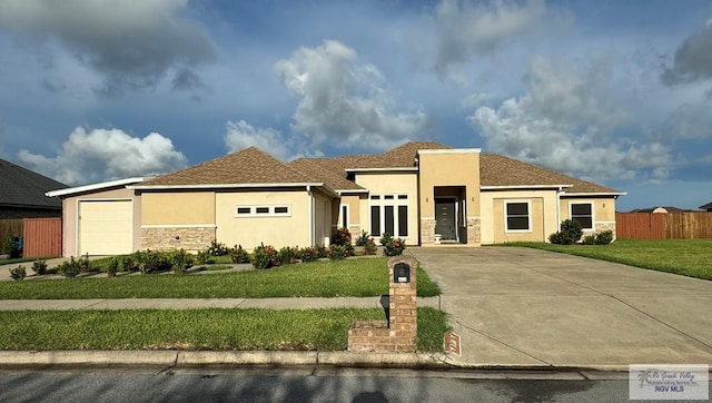 view of front of house featuring a front yard and a garage