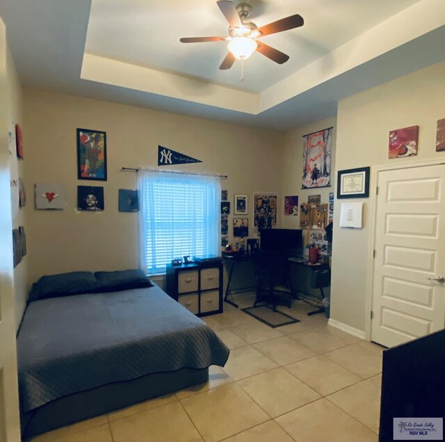 116 Village E Dr, Los Fresnos, TX 78566 - bedroom featuring light tile patterned floors, a raised ceiling, an office area, and a ceiling fan