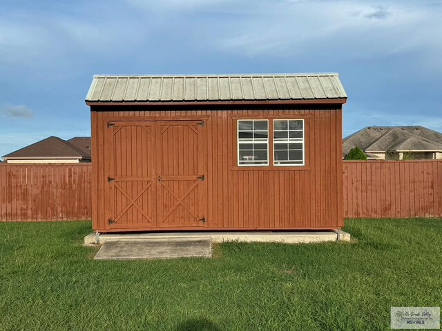 view of outdoor structure featuring a lawn