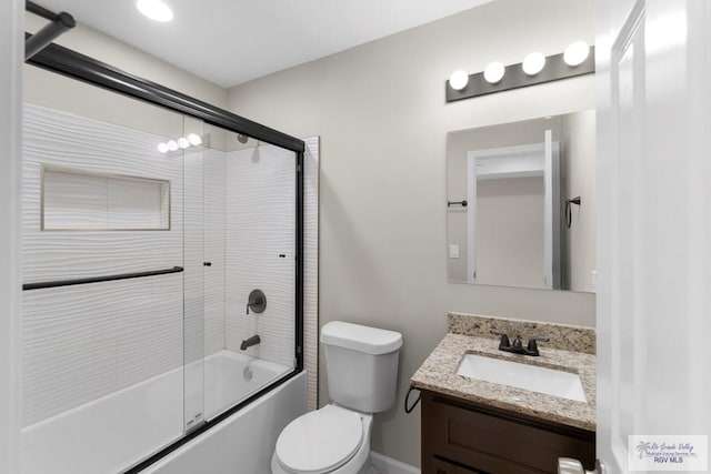 full bathroom with vanity, enclosed tub / shower combo, and toilet