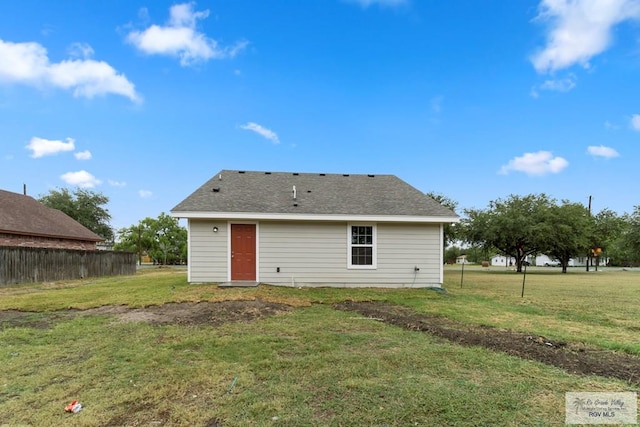 rear view of house featuring a yard