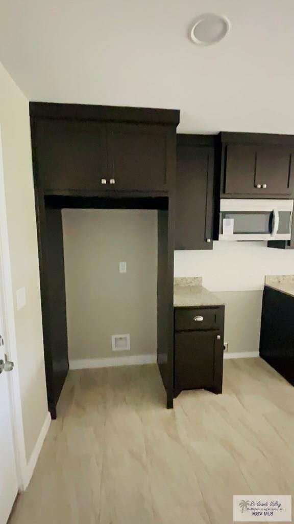 kitchen featuring dark brown cabinetry