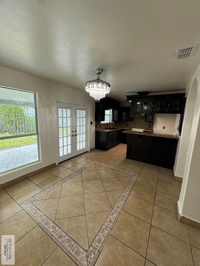 kitchen featuring visible vents, baseboards, an inviting chandelier, french doors, and light tile patterned floors