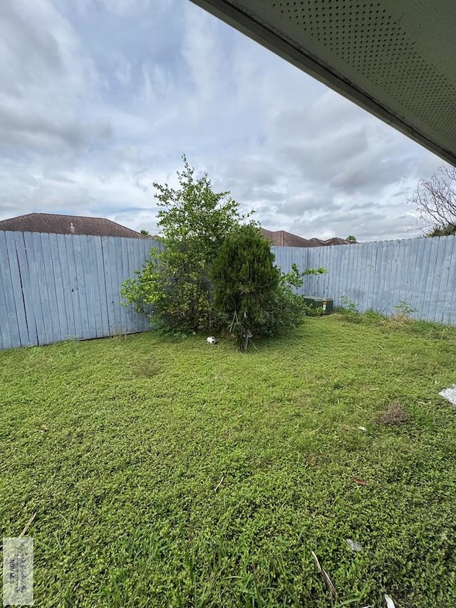 view of yard with a fenced backyard
