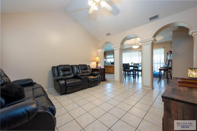 tiled living room with decorative columns, ceiling fan, and lofted ceiling