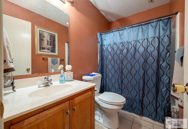 bathroom with tile patterned floors, vanity, toilet, and a textured ceiling