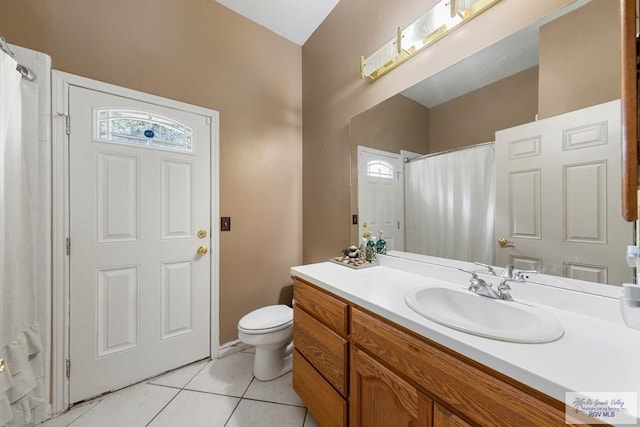 bathroom with tile patterned flooring, vanity, and toilet