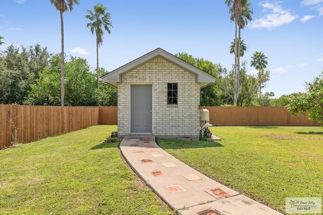 view of outbuilding featuring a lawn