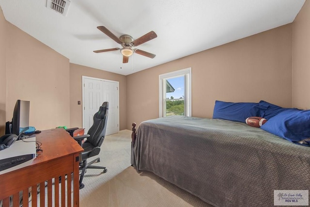 bedroom featuring a closet, light colored carpet, and ceiling fan