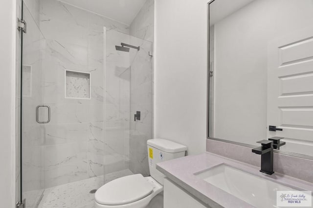 full bathroom with a marble finish shower, toilet, and vanity