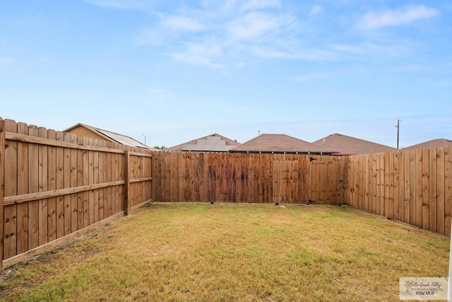 view of yard with a fenced backyard