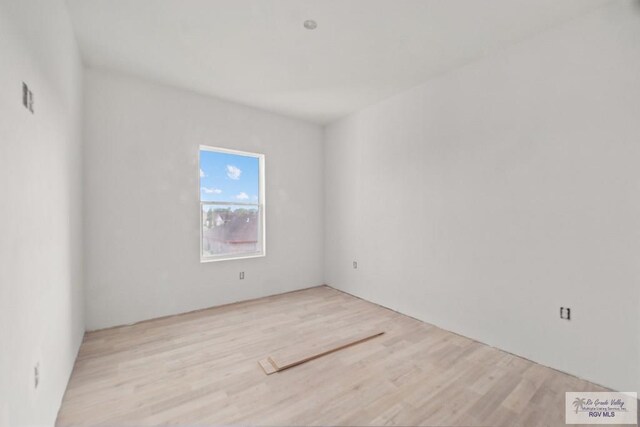 spare room with light hardwood / wood-style flooring