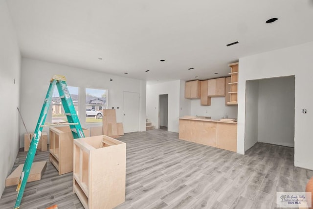 kitchen with light brown cabinets and light wood-type flooring