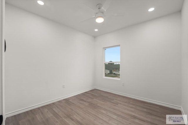 washroom with light hardwood / wood-style floors and electric dryer hookup