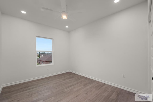 spare room featuring recessed lighting, wood finished floors, baseboards, and ceiling fan