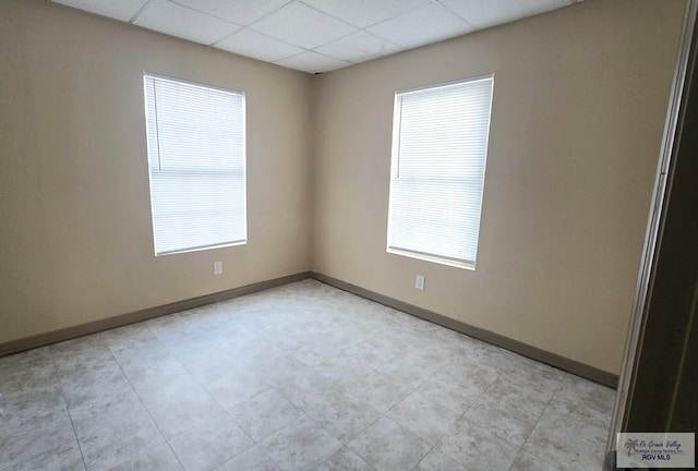 unfurnished room with a paneled ceiling