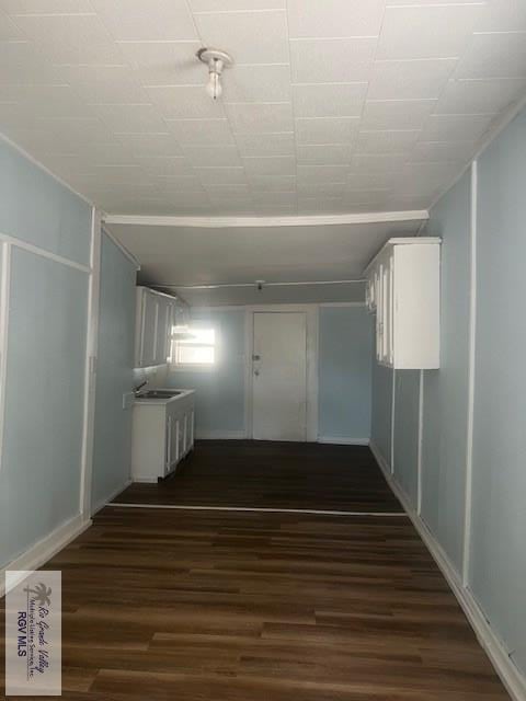 corridor with dark wood-type flooring