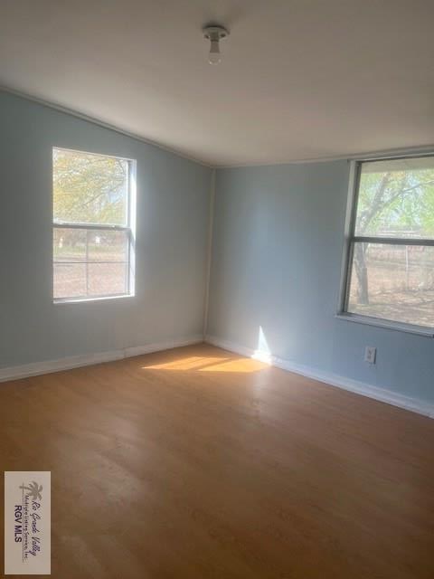 1151 S Texas, Mercedes, TX 78570 - empty room featuring wood finished floors and baseboards