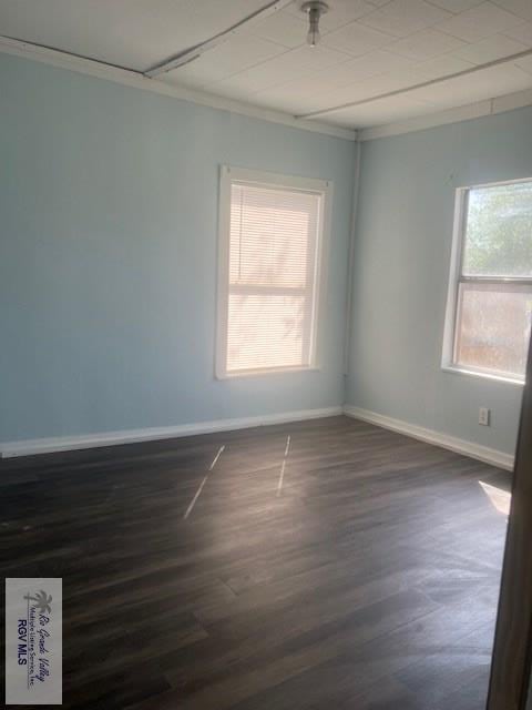 1151 S Texas, Mercedes, TX 78570 - spare room with baseboards, dark wood-style flooring, and ornamental molding
