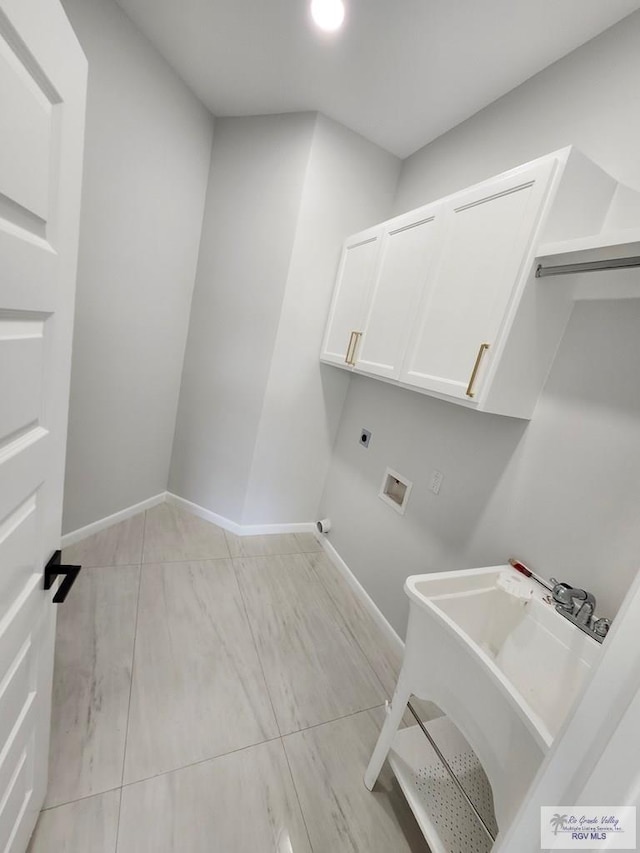 laundry area featuring washer hookup, cabinet space, a sink, electric dryer hookup, and baseboards