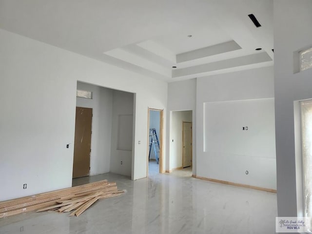 empty room with a high ceiling and a raised ceiling