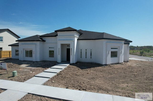 view of front of house with fence and stucco siding