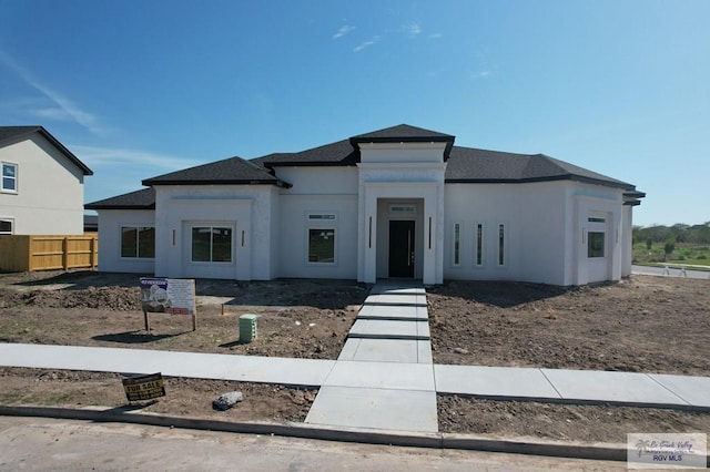 view of front of home with fence and stucco siding