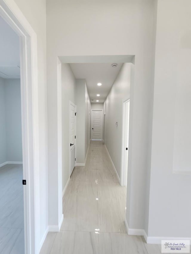 hall featuring baseboards