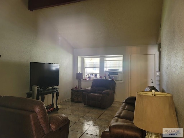 tiled living room with cooling unit and vaulted ceiling