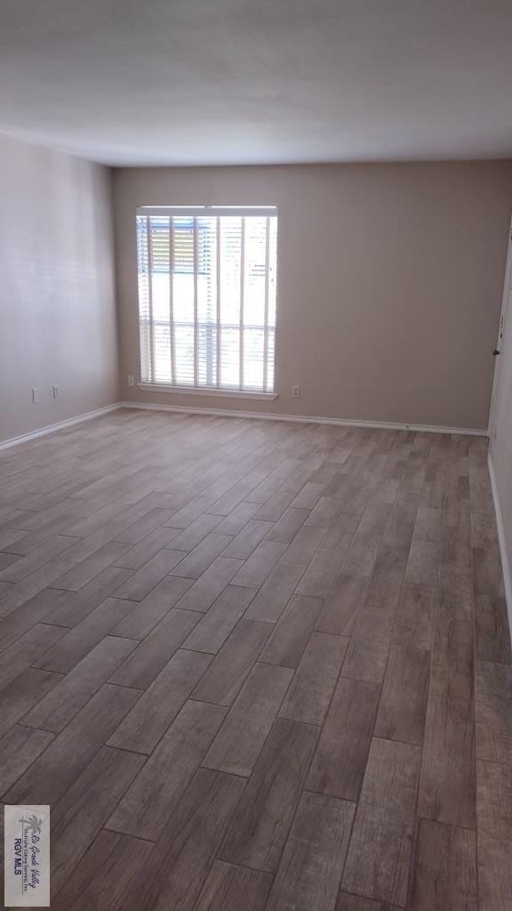 unfurnished room with dark hardwood / wood-style flooring