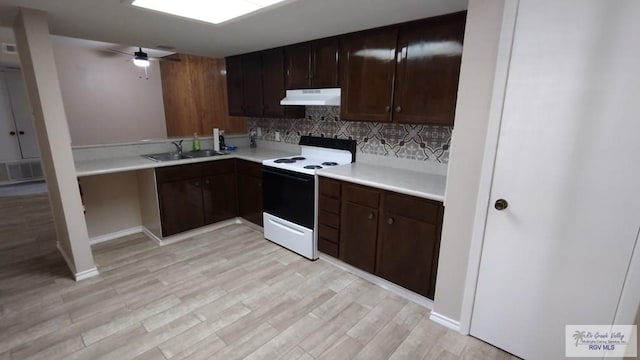 kitchen featuring white range with electric stovetop, dark brown cabinets, sink, and tasteful backsplash