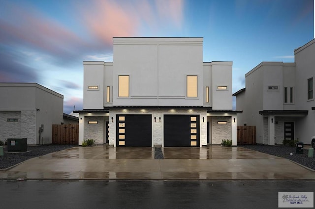 modern home featuring a garage and cooling unit