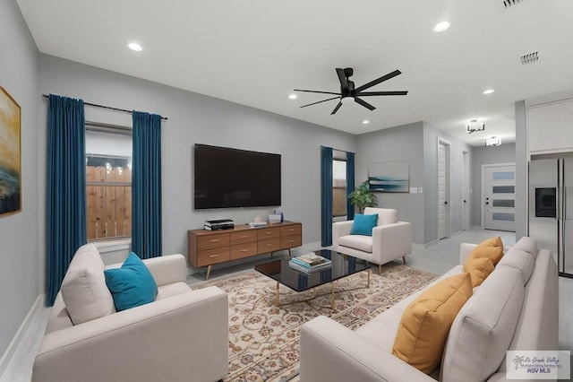 living room featuring a wealth of natural light and ceiling fan