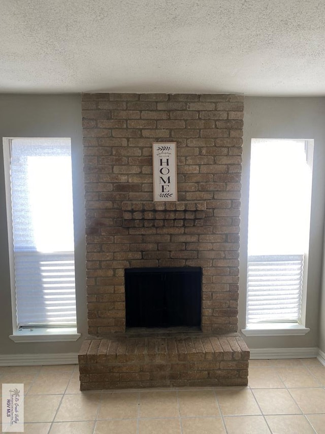 details with a textured ceiling and a brick fireplace