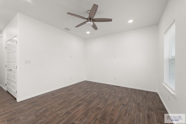 spare room with ceiling fan and dark hardwood / wood-style flooring