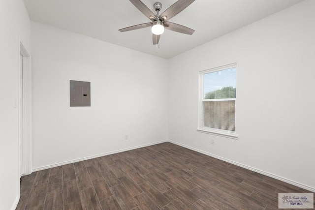 empty room with electric panel, ceiling fan, and dark wood-type flooring