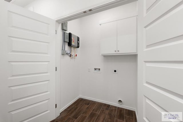 clothes washing area with cabinets, hookup for a washing machine, dark hardwood / wood-style floors, and electric dryer hookup