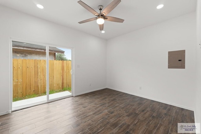 spare room featuring electric panel, ceiling fan, and hardwood / wood-style floors