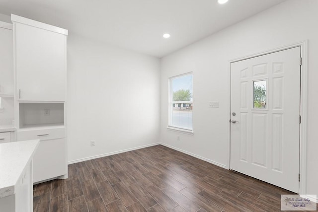 foyer entrance with dark hardwood / wood-style flooring