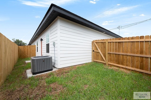 view of property exterior with a yard and cooling unit