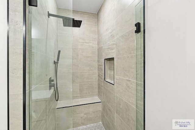 bathroom with tiled shower