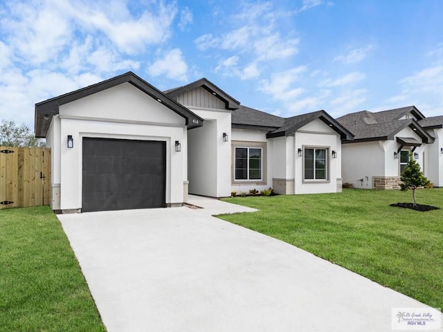 ranch-style house featuring a garage and a front lawn