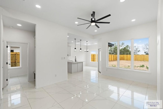 spare room with ceiling fan and sink