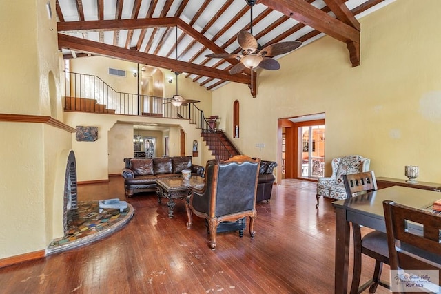 living room featuring beamed ceiling, ceiling fan, a healthy amount of sunlight, and hardwood / wood-style floors