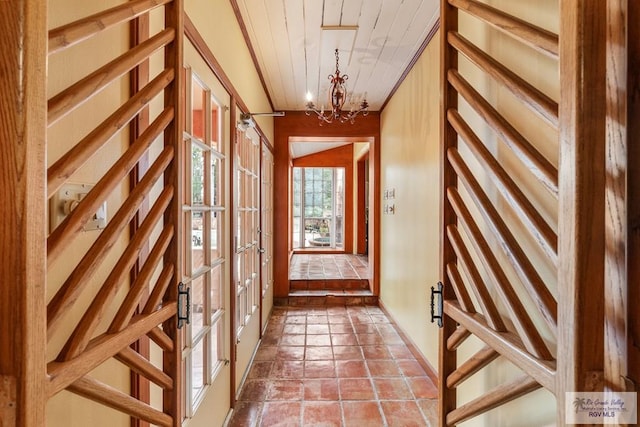 doorway with tile patterned flooring and a chandelier