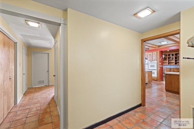 hallway with light tile patterned floors