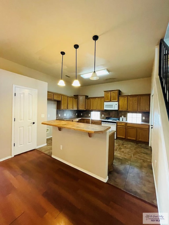 kitchen with butcher block counters, dark hardwood / wood-style floors, pendant lighting, and white appliances