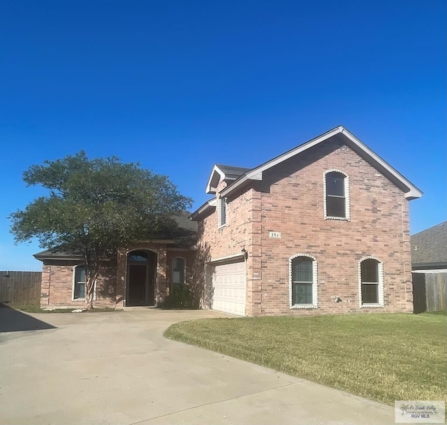 view of front of house featuring a garage and a front lawn