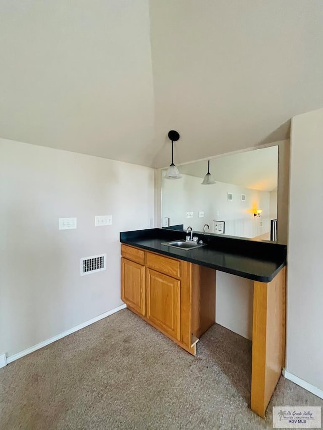 bar featuring light carpet, sink, hanging light fixtures, and lofted ceiling